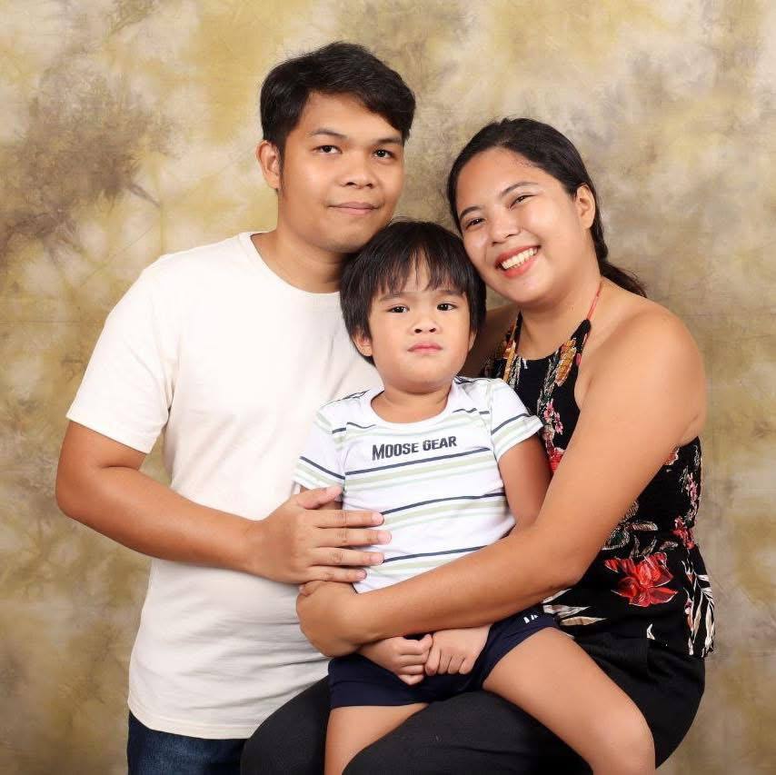 Ingvar posing for a family portrait with his partner and child